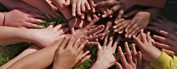 many-children-holding-hands-together-in-the-center